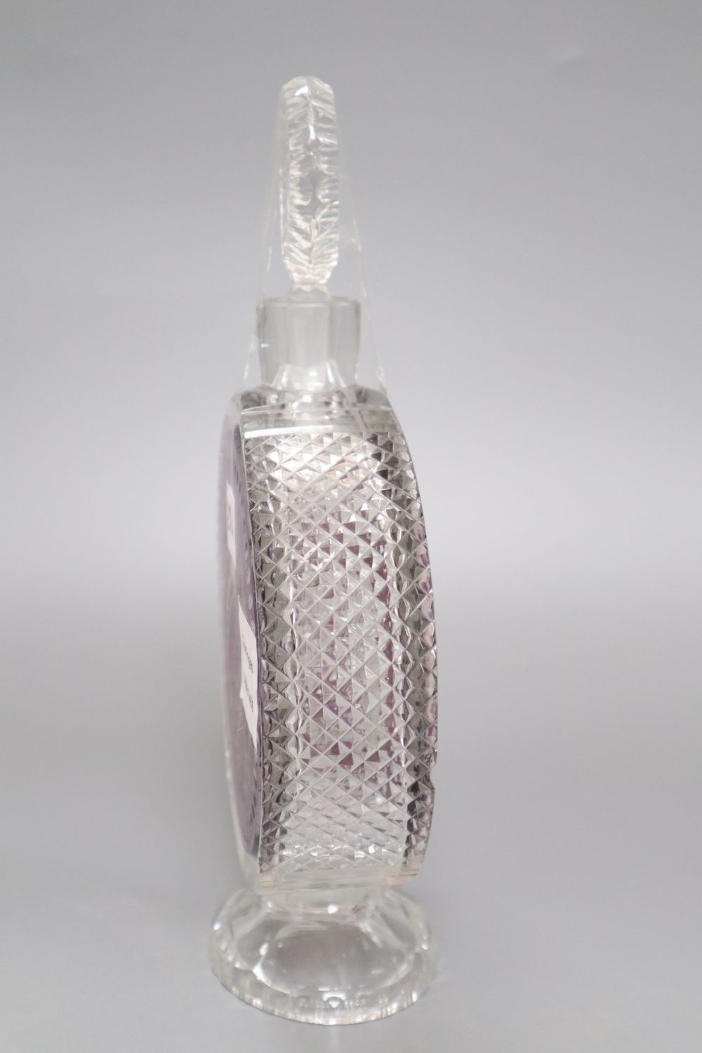 An amethyst overlaid cut glass decanter, height 27cm (a.f.)